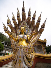 Fototapeta na wymiar Golden Statue of The Angel in The Nine Headed Serpent