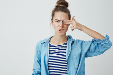 Daring good-looking confident young 25s woman hair rolled hairbun, frowning grimacing cute biting...
