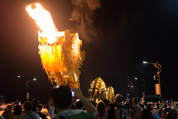Da Nang bridge dragon spits fire in the dark of night surrounded by the crowd of spectators. This...