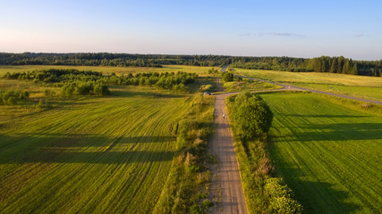 Fototapeta na wymiar Top view of a country road through an agricultural field