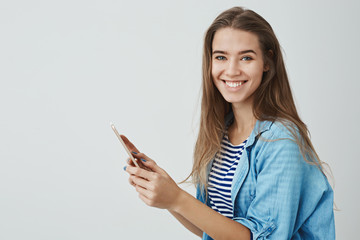 Charming happy smiling girl holding digital tablet enjoying using brand new gadget turning camera grinning joyfully studying device bday gift amused, enjoying leisure film watching, white background