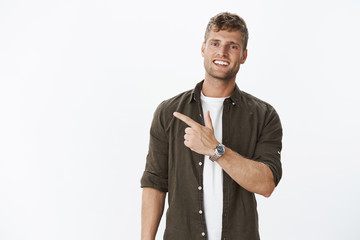 Guy showing us cool place inviting join. Friendly-looking sociable and carefree handsome masculine...