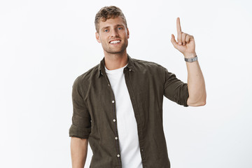 Looking up to top. Portrait of charming friendly-looking masculine male with bristle and white...