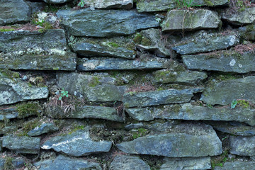 background or Texture of a Dry Stone Wall Covered with Lichens