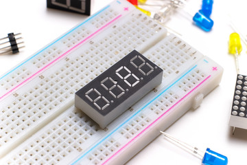 Breadboard close-up, seven segment indicators and color led lamp.