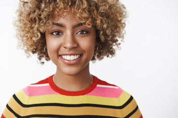 Headshot of attractive tender and friendly-looking outgoing joyful young dark-skinned woman with...