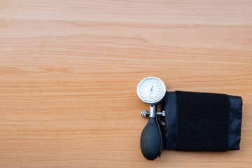 sphygmomanometer on wooden texture background