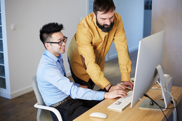 Coworking Process Businessman Desktop Connecting Networking Concept. Two confident young men looking at desktop monitor