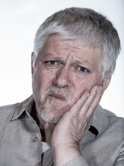 Portrait of a senior man with a toothache. Concept health.