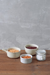 Varieties of nuts: soy nuts, hazelnuts and red beans with sugar in glass jar. Food and cuisine.