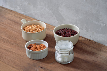 Varieties of nuts: soy nuts, hazelnuts and red beans with sugar in glass jar. Food and cuisine.