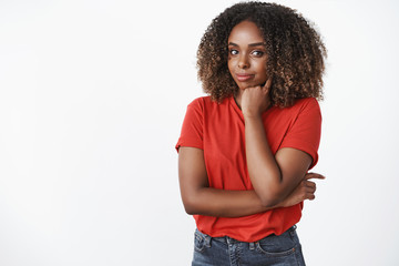 Indoor shot of creative and confident good-looking young african-american woman in red t-shirt...