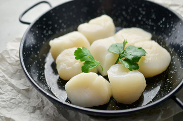 Raw scallops on skillet