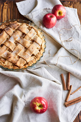 american apple pie and ingredients on wooden background. Top view.