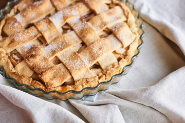 Homemade apple pie on the brown wooden table. Apple tart with lattice top overhead view. Rustic style