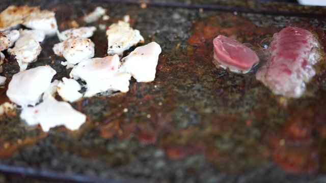 Meat cooking on hot stone grill