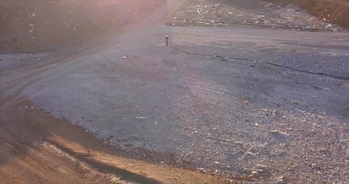 Aerial view of garbage pile in a landfill at sunset