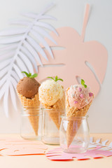 Waffle cones with strawberry, vanilla, chocolate ice cream