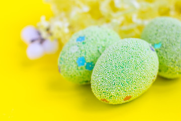 Easter background with eggs on yellow. Easter eggs
