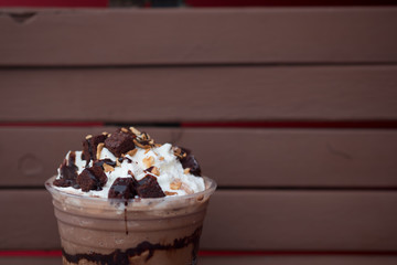 Iced chocolate drink decorated with whipped cream and brownies