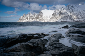 Okneset and Ersfjord from Tungeneset on a stormy day with breaking waves and spray. Sunny day in Mountains And Fjords, Winter Landscape, Norway Beautiful christmas time near Troms county. 