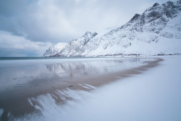Amazing day in Mountains And Fjords, Winter Landscape, Norway Clouds sky on the Norwegian Alps and the blue hour begins in range at Senja, Norway. Beautiful christmas time near Troms county.
