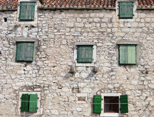 Fototapeta na wymiar Facade of old traditional mediterranean stone house