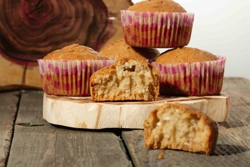 homemade muffins with coconut chips on a wooden stand