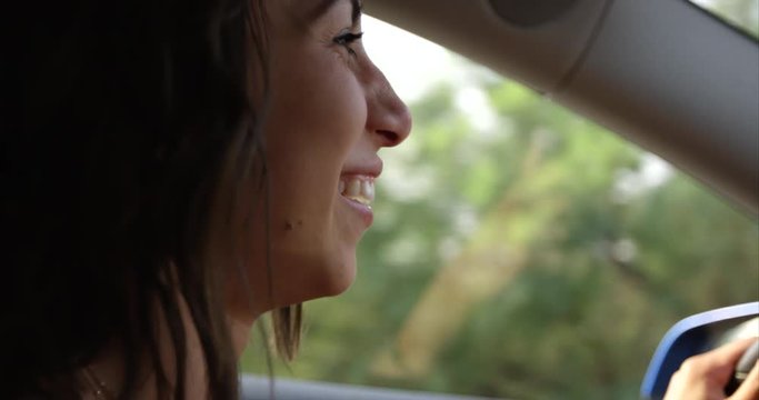 Young woman driving car - close up side profile