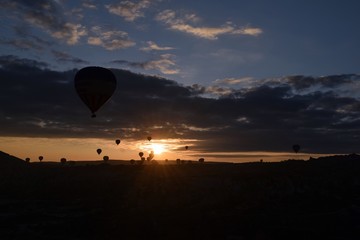 Sunrise and balloons. Beautiful background of the balloon and the sunset.Cappadocia. Turkey. Göreme. Nevşehir. Türkiye. 8. 04. 2019. Balloons flying over the rocky landscape in Cappadocia Turkey. 