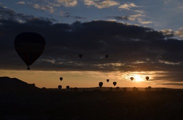 Sunrise and balloons. Beautiful background of the balloon and the sunset.Cappadocia. Turkey. Göreme. Nevşehir. Türkiye. 8. 04. 2019. Balloons flying over the rocky landscape in Cappadocia Turkey. 