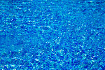 Blue pool water with sun reflections