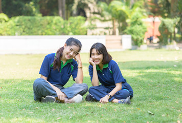 Happy cute students smile and sitting on grass