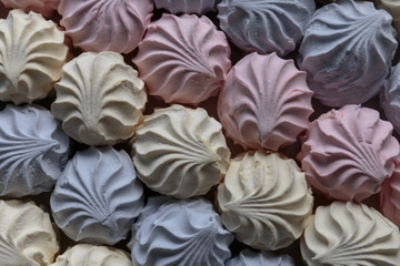 Multicolor fruity zephyr. Closeup of dessert with raspberry, blueberry and banana flavor. Natural product, ready for sale.