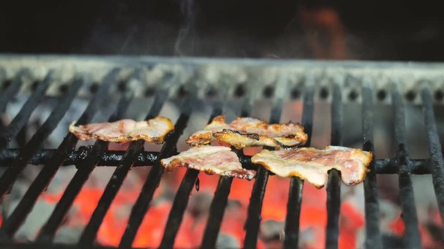 Fresh becon cooking on grill bbq