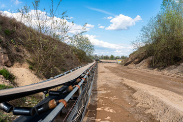A string of transport belting in a gravel pit for transporting gravel and sand over long distances,...