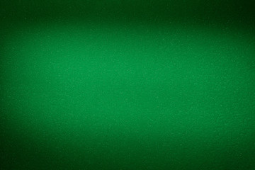 Blurred textural cloud of light green on a green background