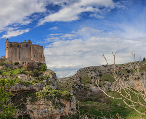 Fototapeta na wymiar The old town of Matera with the Convent of Saint Agostino sitting on a steep cliff overlooking a canyon ravine filled with prehistoric sassi caves.The Unesco World Heritage site in Basilicata, Italy.