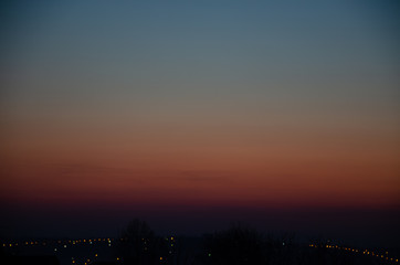 Fototapeta premium Incredible, beautiful, Bright sunset over the city. Gradient, the core of the sun. Beautiful sunset, red, orange