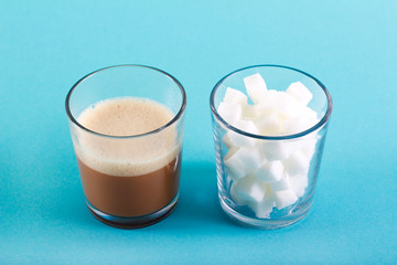 Glass of coffee drink and glass of sugar