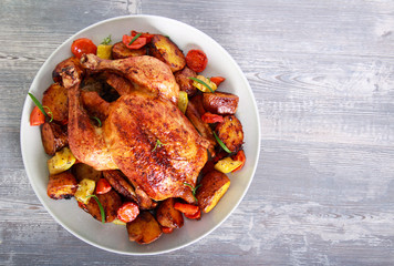 Roast chicken with vegetables on plate, © manyakotic