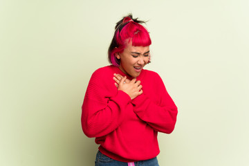 Young woman with red sweater having a pain in the heart