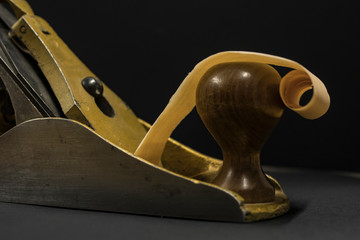 hand plane on a black background. shavings