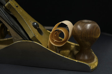 hand plane on a black background. shavings