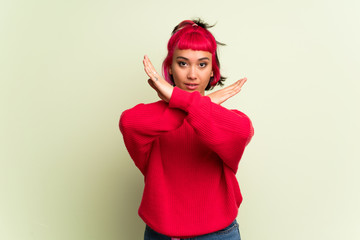 Young woman with red sweater making NO gesture