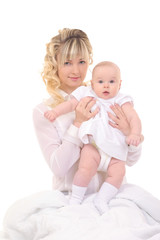 cheerful beautiful young woman holding baby in hands