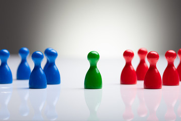 Colorful Pawns On The Reflective Desk