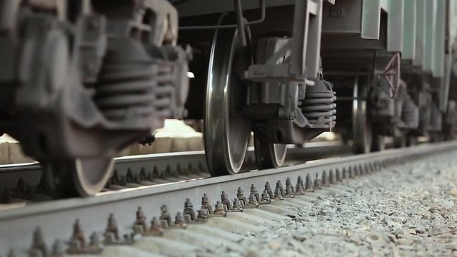 The wheels of old train on the railway track passing by camera. Close up shot