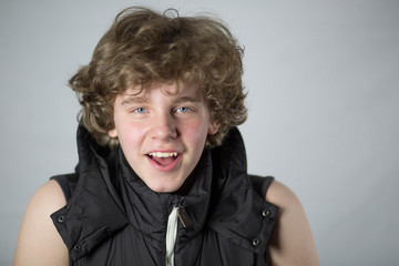 Portrait of teenage boy smiling on white background.
