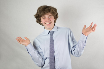 Portrait of teenage boy smiling on white background.